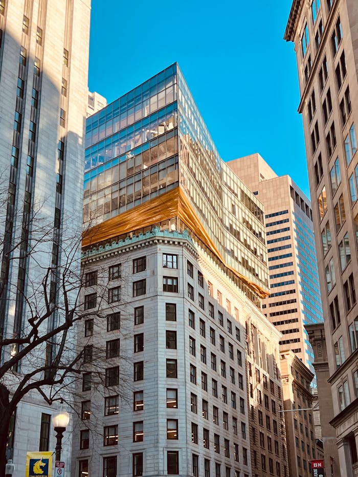 High-rise buildings under a clear blue sky in a bustling city center.